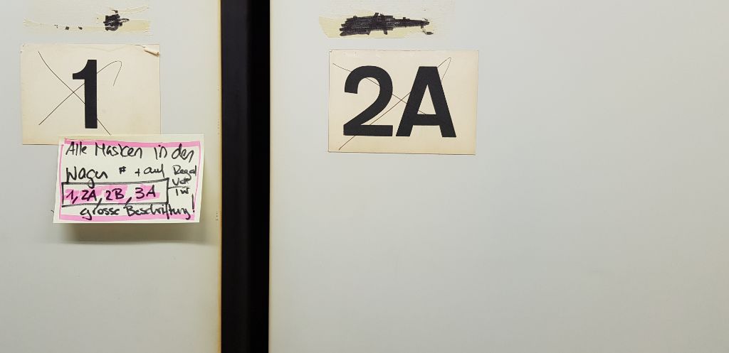 An einem der Schränke hängt eine Botschaft, mit schwarz und pink geschrieben auf Post-Its. 
